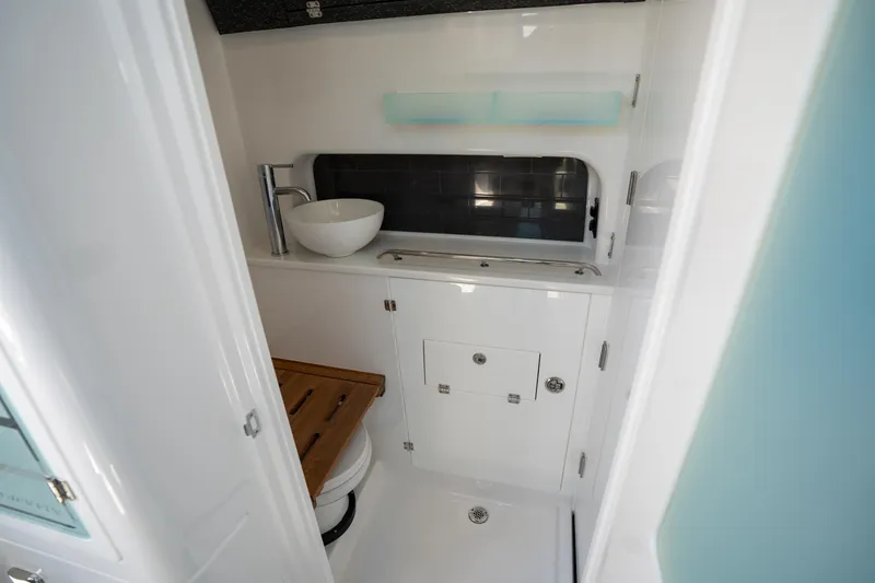 Slide: The Image of 2024 Blackfin 400CC boat bathroom with modern sink and wooden seat. - 44