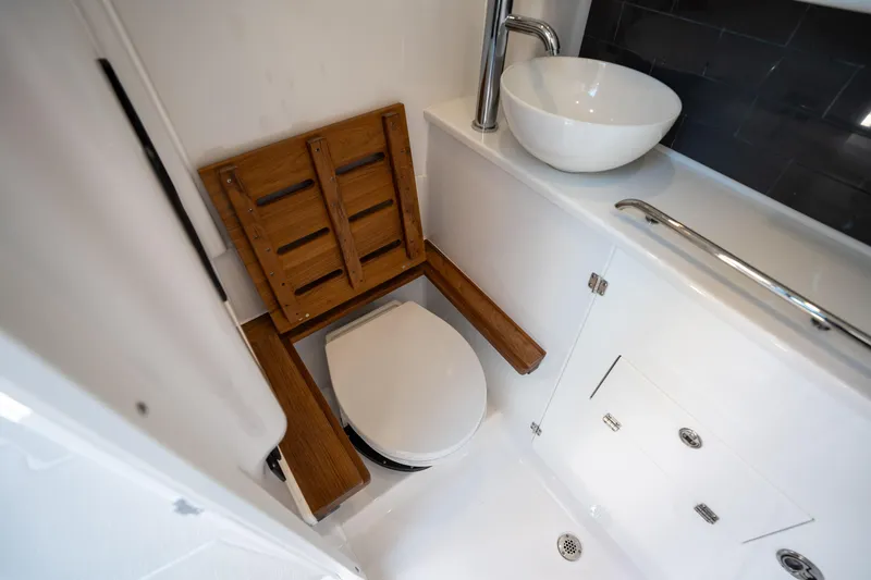 Slide: The Image of 2024 Blackfin 400CC boat bathroom with wooden seat, modern sink, and sleek design. - 46