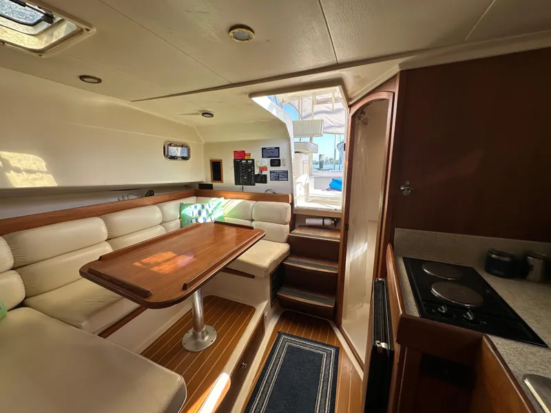 Slide: The Image of Interior of 2002 Mainship Pilot 34 boat with dining area and kitchenette. - 11