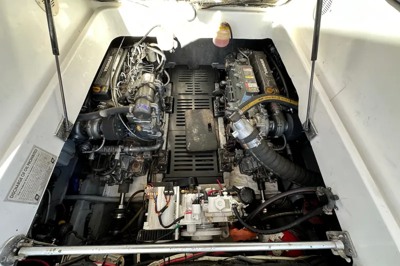 Slide: The Image of Engine compartment of a 2002 Mainship Pilot 34 boat, showcasing dual engines and mechanical components. - 14
