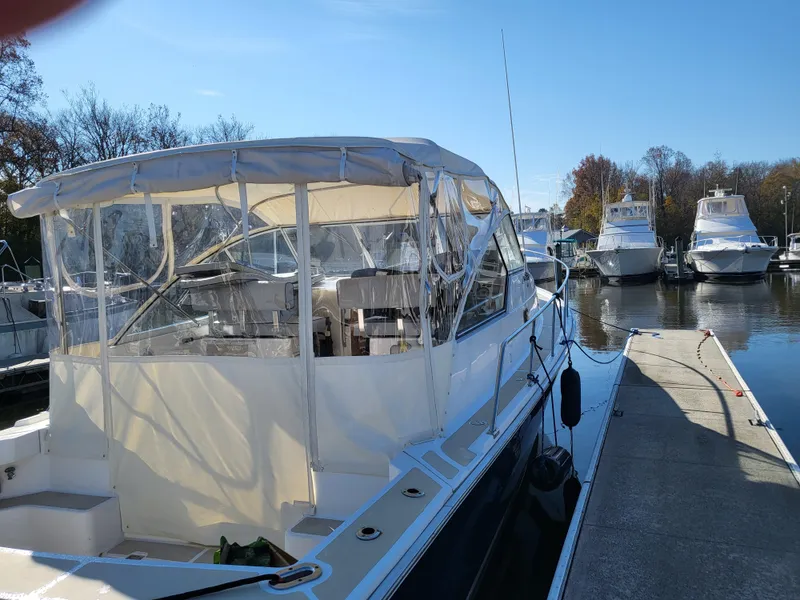 Slide: The Image of 2002 Mainship Pilot 34 docked at marina under clear blue sky. - 4