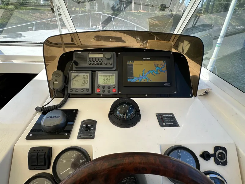 Slide: The Image of 2002 Mainship Pilot 34 helm with navigation equipment and controls. - 5