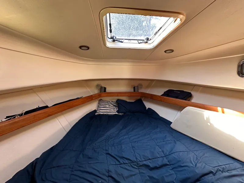 Slide: The Image of Cozy cabin interior of 2002 Mainship Pilot 34 with skylight and bedding. - 9
