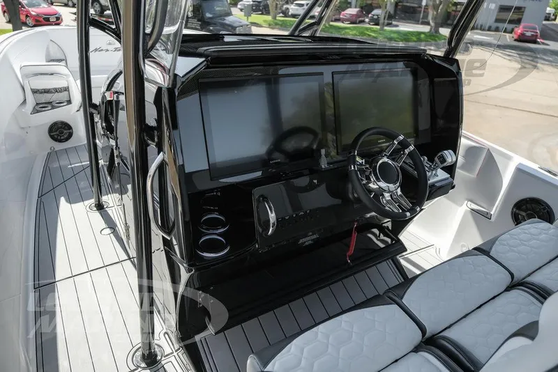 Slide: The Image of 2025 Nor-Tech 340 Sport Center Console interior with modern dashboard and steering wheel. - 10