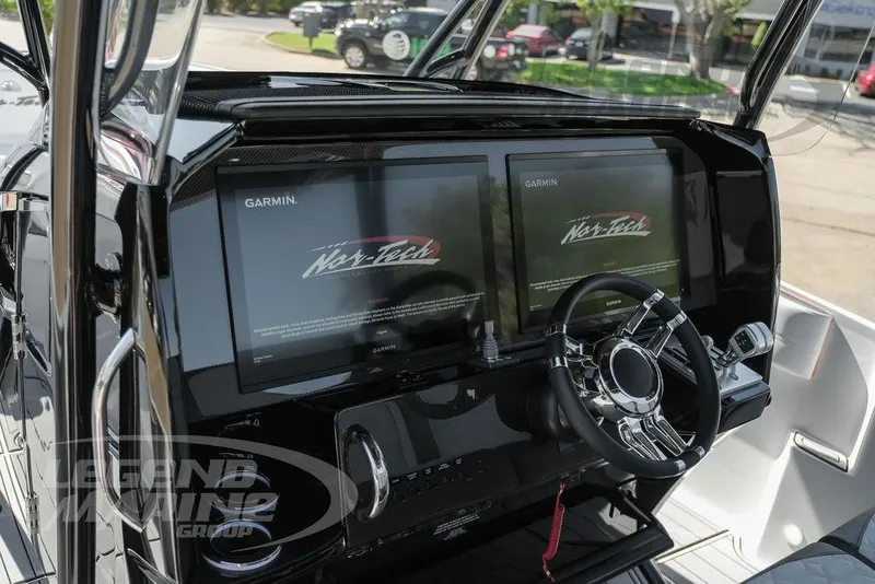 Slide: The Image of 2025 Nor-Tech 340 Sport Center Console dashboard with dual Garmin displays and sleek steering wheel. - 15