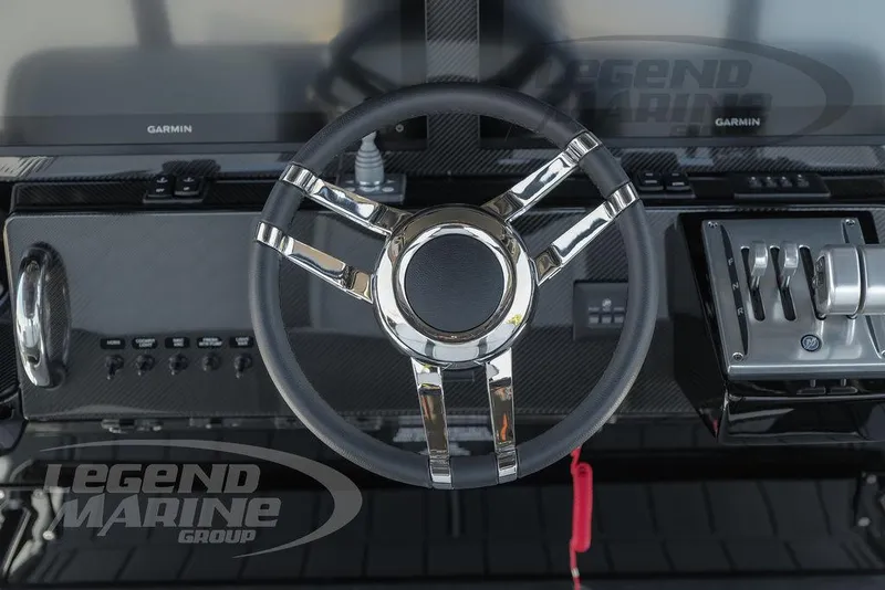 Slide: The Image of Steering wheel of 2025 Nor-Tech 340 Sport Center Console boat with modern controls. - 16
