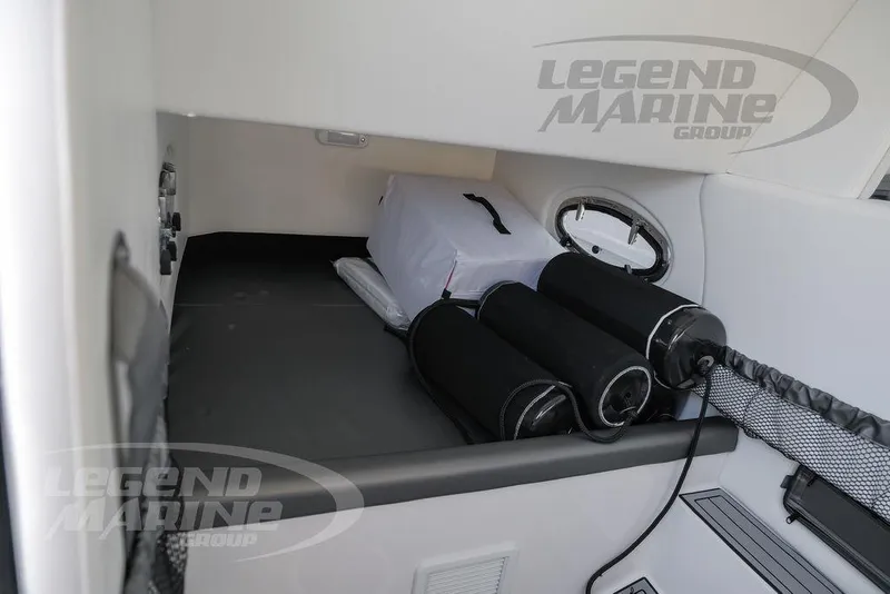 Slide: The Image of Interior cabin of 2025 Nor-Tech 340 Sport Center Console boat with storage and porthole. - 23