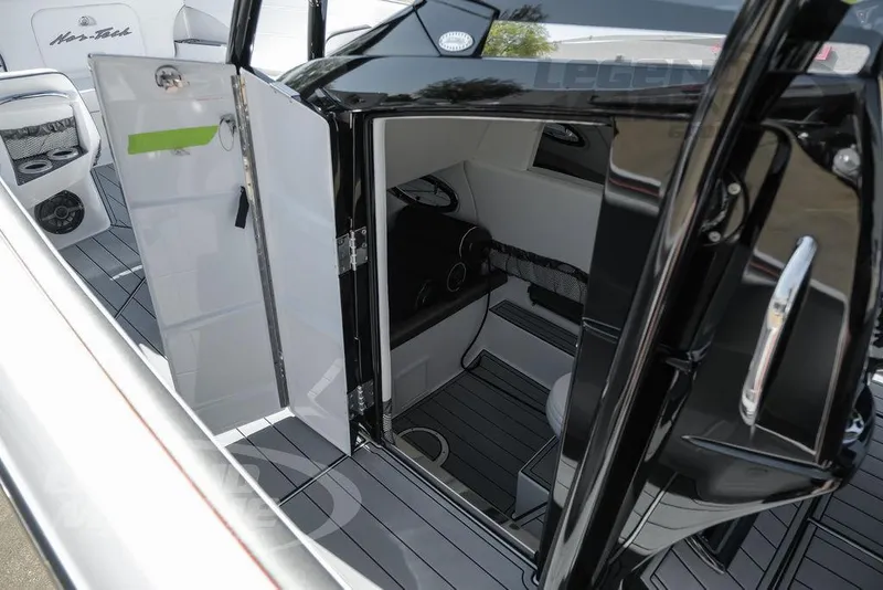 Slide: The Image of 2025 Nor-Tech 340 Sport Center Console interior with open cabin door. - 27