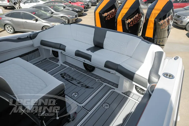 Slide: The Image of 2025 Nor-Tech 340 Sport Center Console boat interior with seating and powerful engines. - 29
