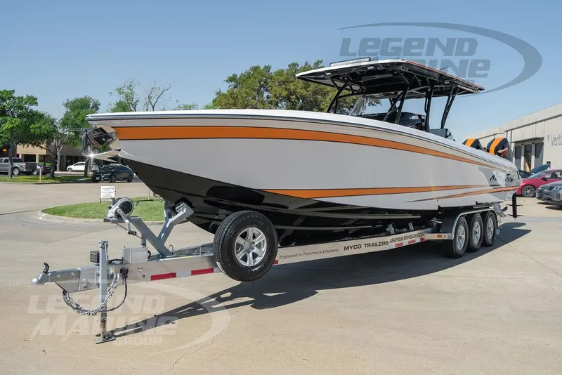 Slide: The Image of 2025 Nor-Tech 340 Sport Center Console boat on trailer in parking lot. - 4