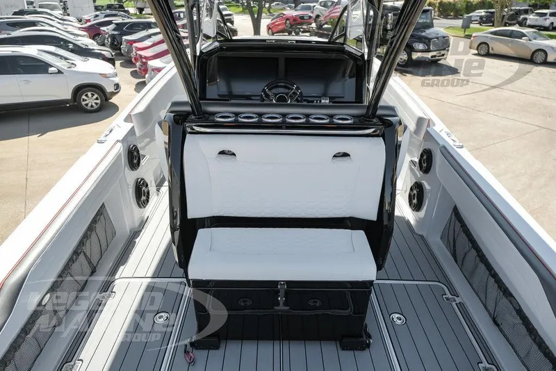 Slide: The Image of 2025 Nor-Tech 340 Sport Center Console boat interior with seating and steering wheel. - 40