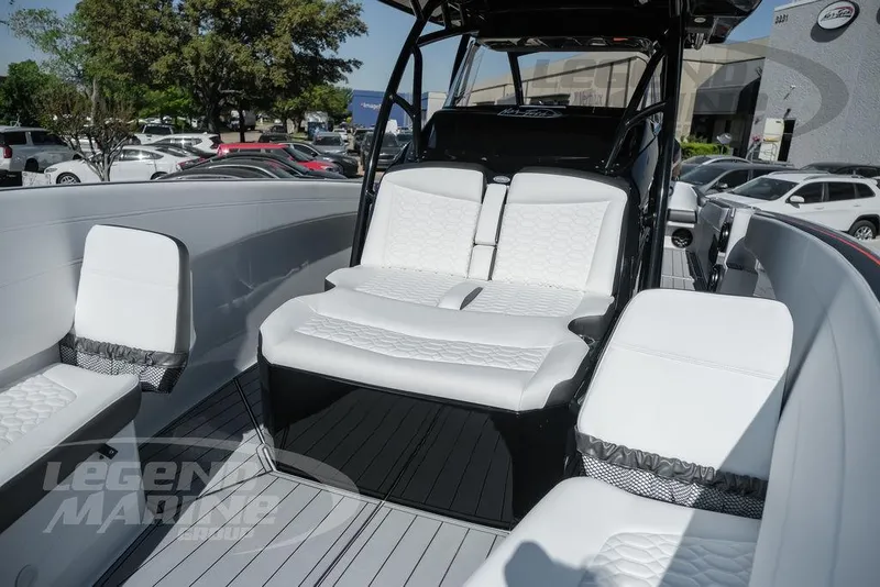 Slide: The Image of 2025 Nor-Tech 340 Sport Center Console with white seating, docked outdoors. - 43