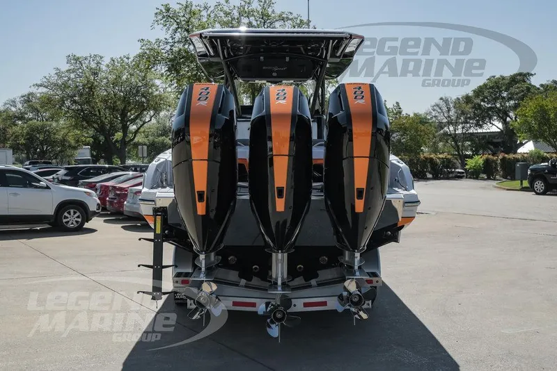 Slide: The Image of 2025 Nor-Tech 340 Sport Center Console with triple outboard engines, rear view. - 6