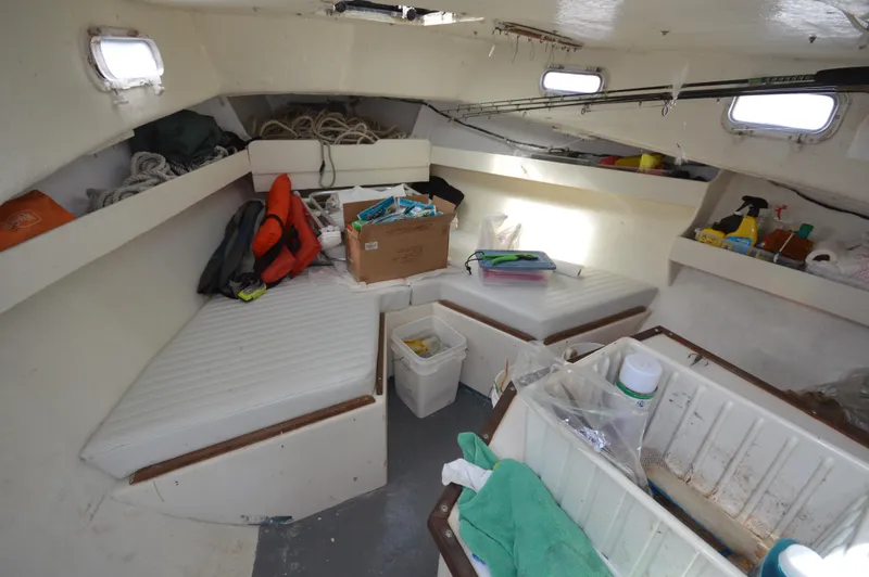Slide: The Image of Interior of 1983 BHM 25 EXPRESS boat with storage and seating areas. - 12