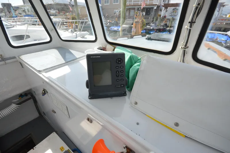 Slide: The Image of Interior of 1983 BHM 25 EXPRESS boat with navigation equipment and windows. - 8