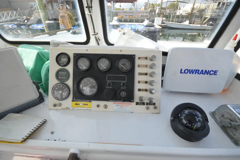 Slide: The Image of Control panel of a 1983 BHM 25 EXPRESS boat with gauges and Lowrance equipment. - 9