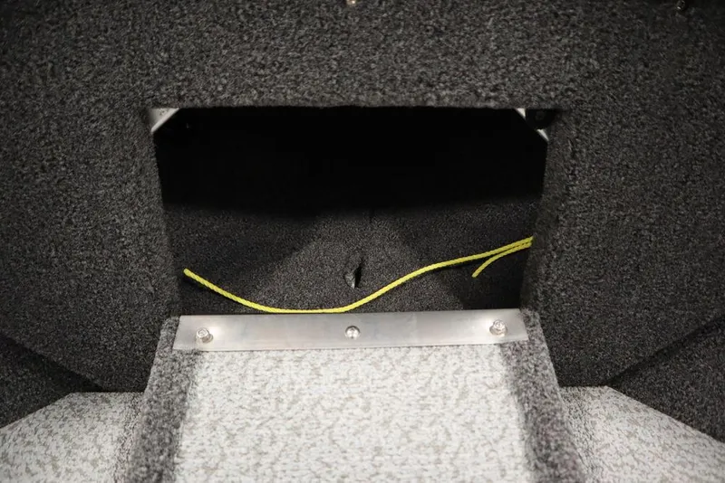 Slide: The Image of 2025 Crestliner 1950 Super Hawk interior storage compartment with carpeted finish and yellow wiring. - 12