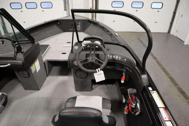 Slide: The Image of 2025 Crestliner 1950 Super Hawk boat interior with steering wheel and seating. - 18