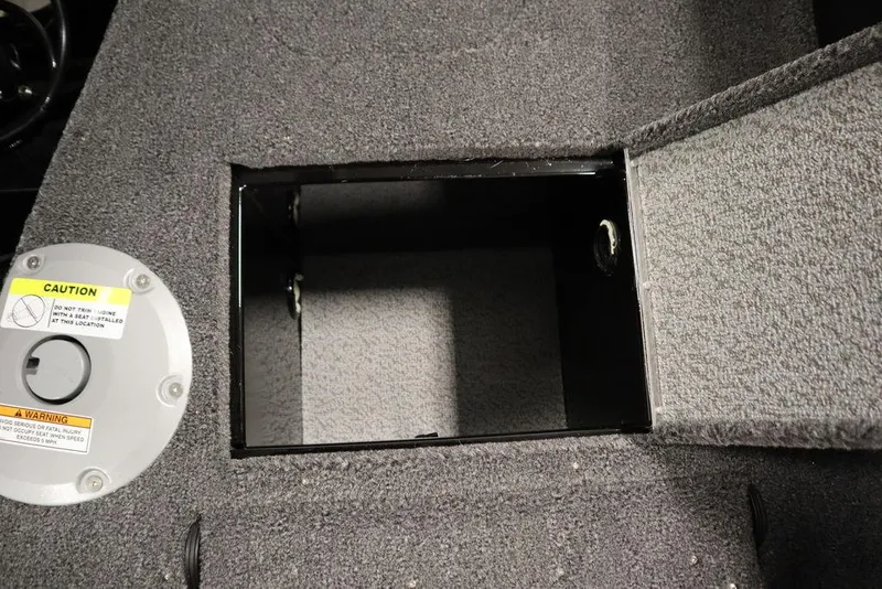 Slide: The Image of 2025 Crestliner 1950 Super Hawk storage compartment with open hatch and caution label. - 34