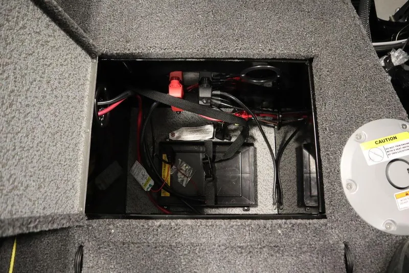 Slide: The Image of 2025 Crestliner 1950 Super Hawk battery compartment with wiring and safety features. - 35