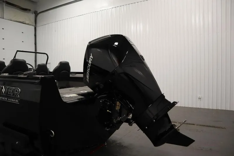 Slide: The Image of 2025 Crestliner 1950 Super Hawk boat with Mercury outboard motor in a garage. - 37