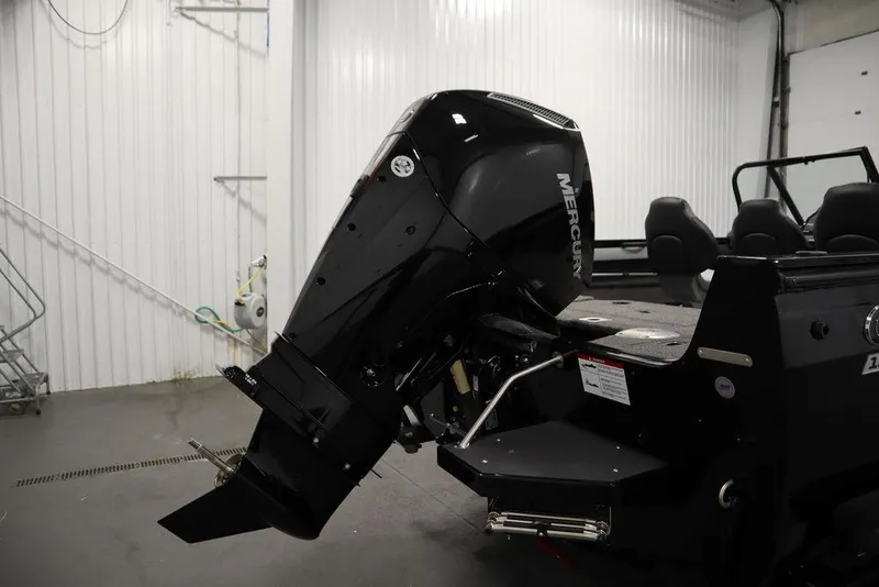 Slide: The Image of 2025 Crestliner 1950 Super Hawk with Mercury outboard motor in a garage setting. - 38