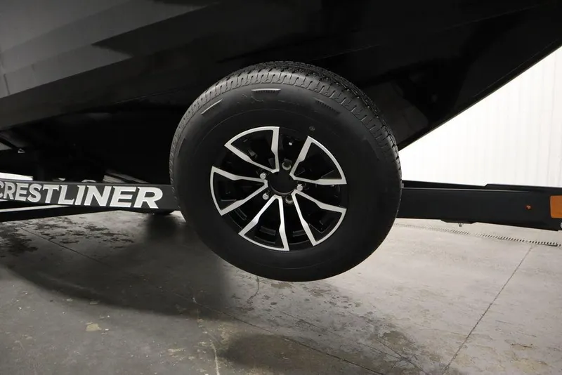 Slide: The Image of Trailer wheel of 2025 Crestliner 1950 Super Hawk boat in a garage setting. - 41