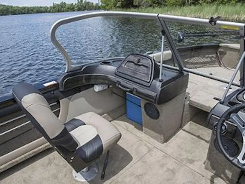 Slide: The Image of 2025 Crestliner 1950 Super Hawk interior with seating and steering, near a serene lake. - 47
