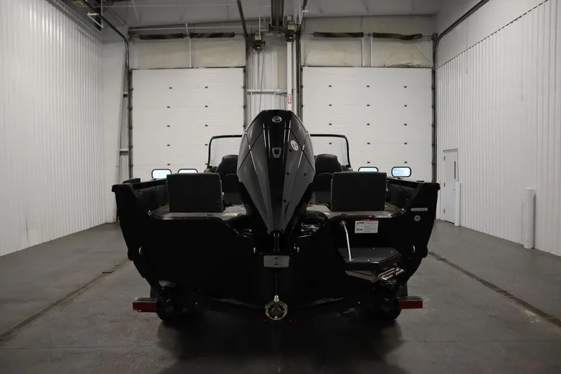 Slide: The Image of 2025 Crestliner 1950 Super Hawk boat in a garage, rear view. - 6