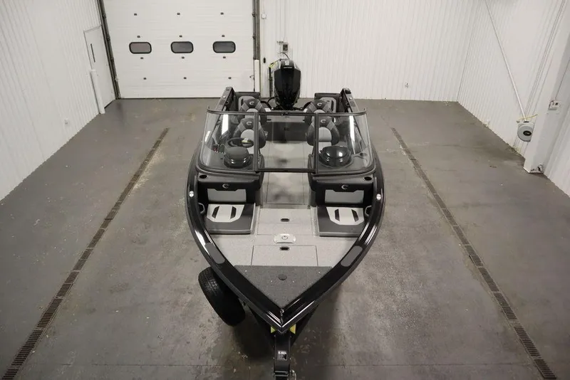 Slide: The Image of 2025 Crestliner 1950 Super Hawk boat in a spacious indoor garage. - 9