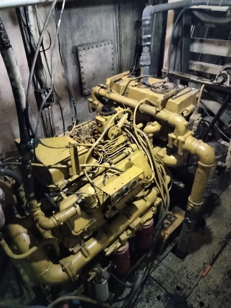 Slide: The Image of Engine room of a 1972 commercial shrimp freezer trawler, showcasing complex machinery and pipes. - 11