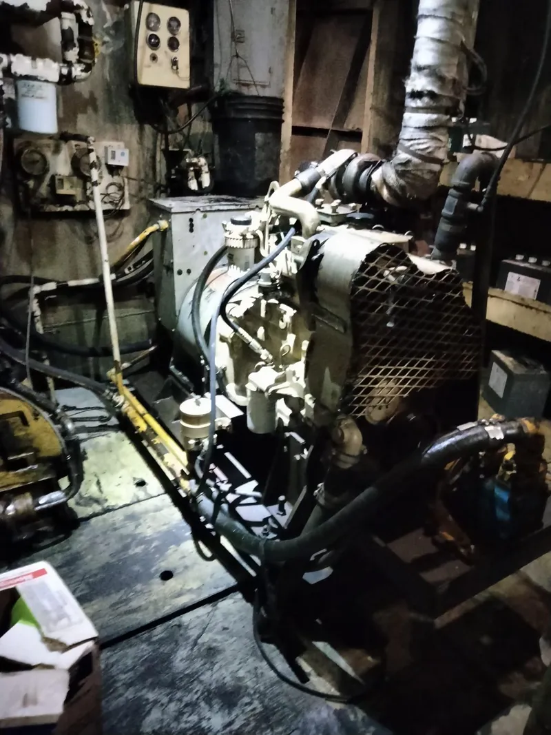 Slide: The Image of Engine room of a 1972 Commercial Shrimp Freezer Trawler, featuring machinery and pipes. - 14