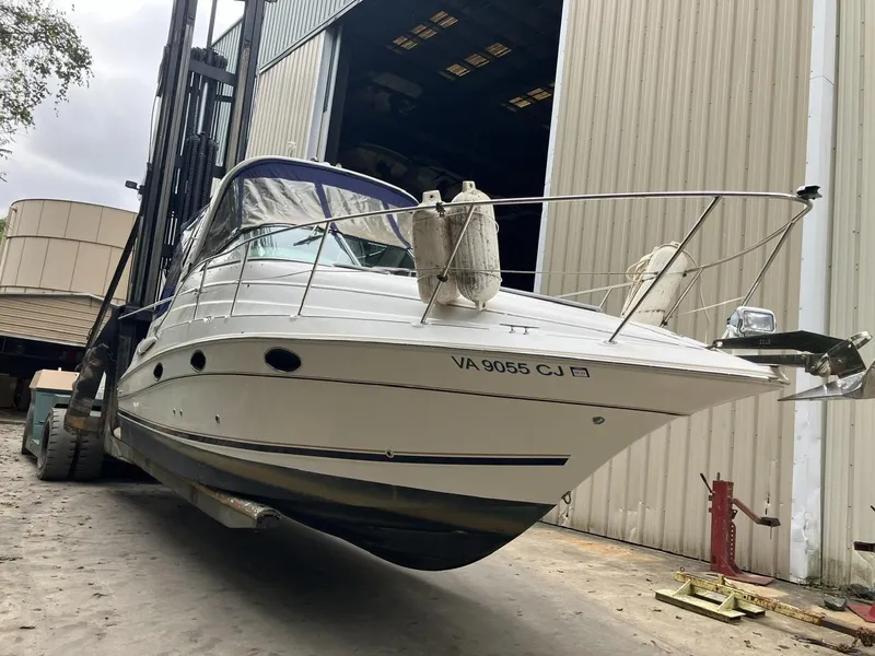 Slide: The Image of 2001 Doral 270 SC boat on forklift near warehouse entrance. - 1