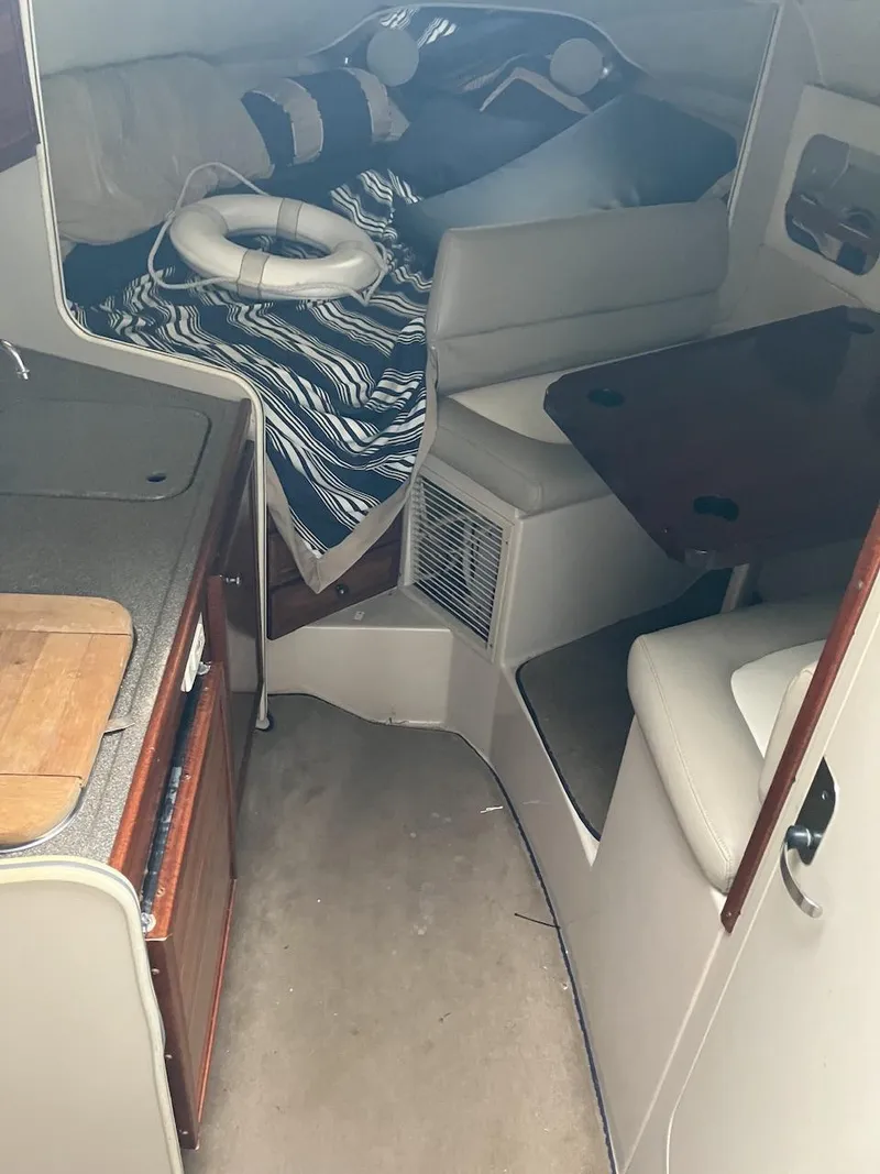 Slide: The Image of Interior of 2001 Doral 270 SC boat with seating, table, and life preserver. - 10