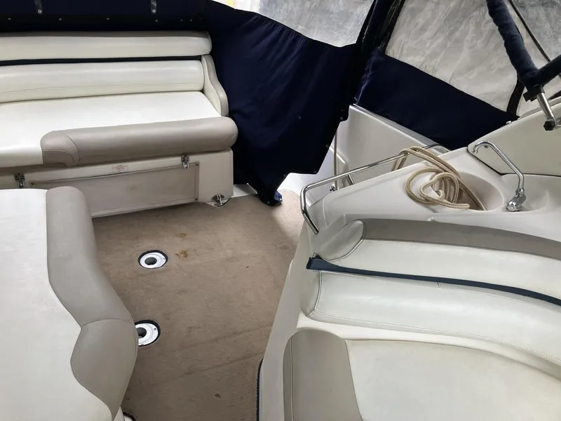 Slide: The Image of 2001 Doral 270 SC boat interior with beige seating and navy accents. - 11
