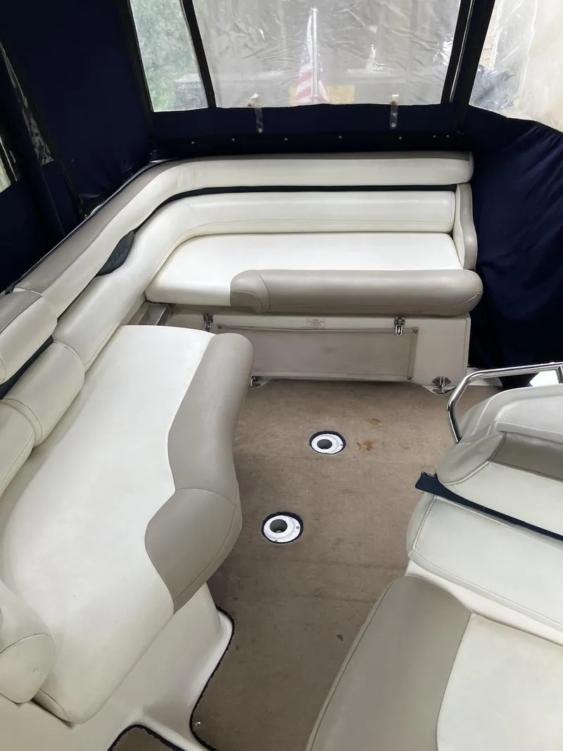 Slide: The Image of 2001 Doral 270 SC boat interior with white seating and carpeted floor. - 12