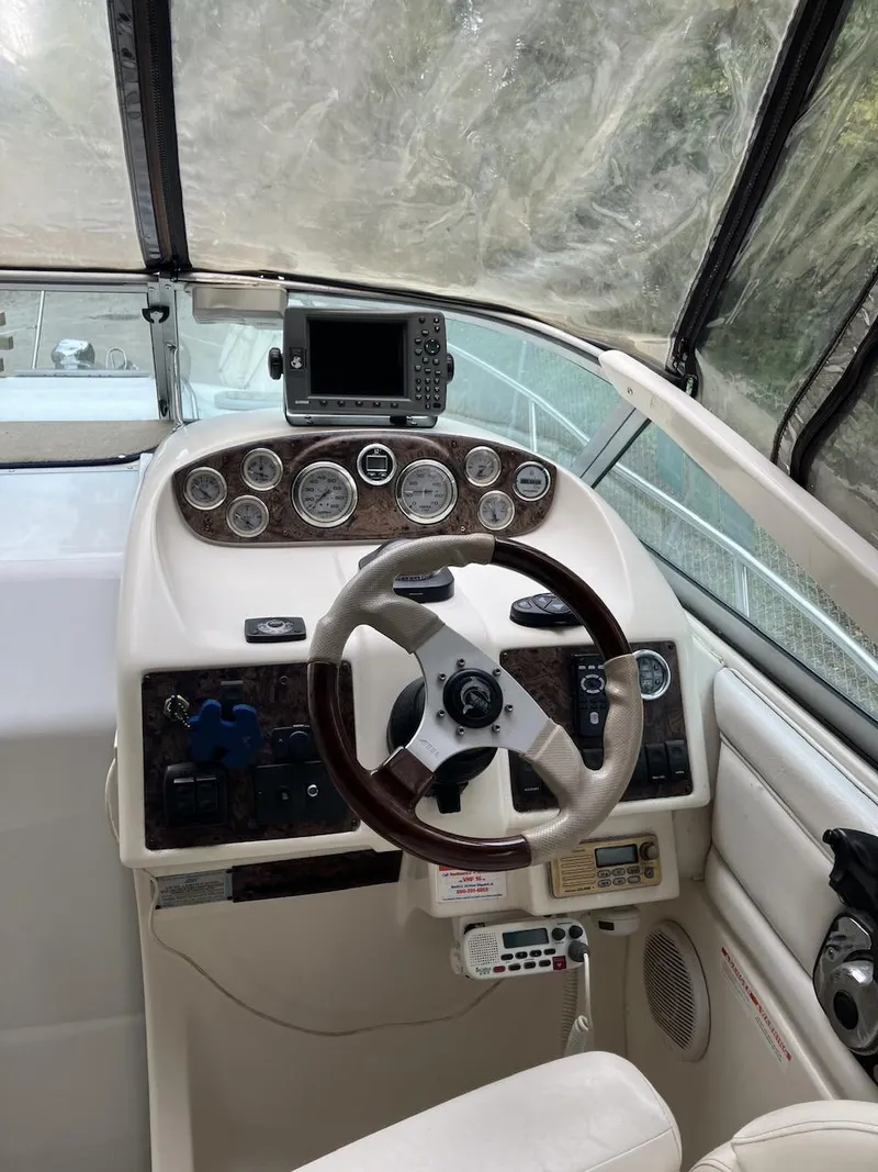 Slide: The Image of 2001 Doral 270 SC boat cockpit with steering wheel and navigation instruments. - 14