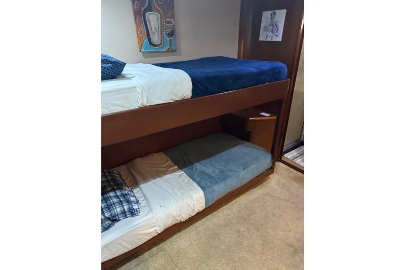 Slide: The Image of Bunk beds in 1987 Ocean Yachts 63 convertible Manns, featuring cozy bedding and nautical decor. - 14
