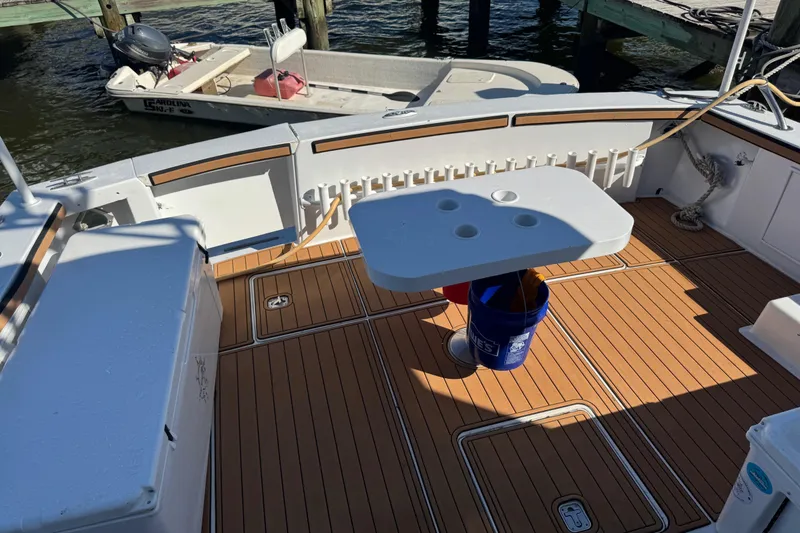 Slide: The Image of 1987 Ocean Yachts 63 Convertible Manns boat deck with table and bucket. - 26