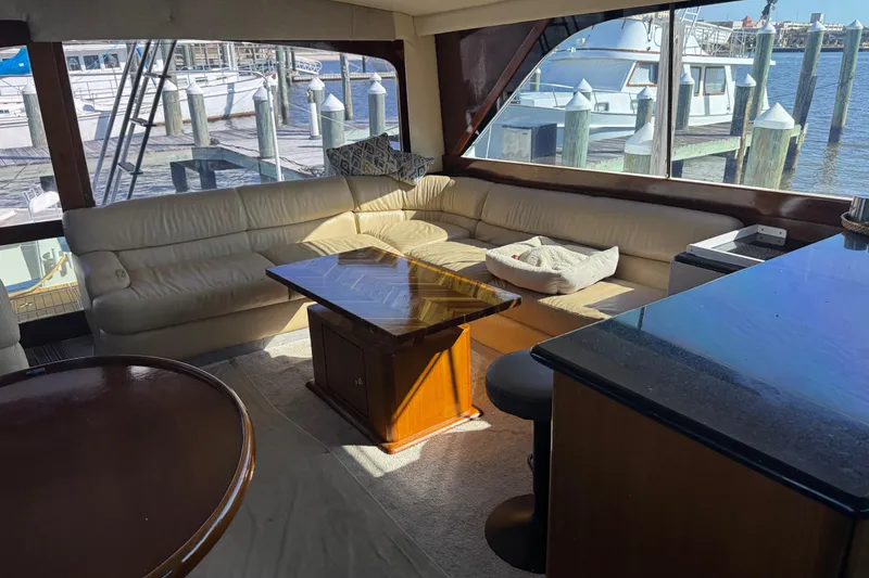 Slide: The Image of Luxurious interior of 1987 Ocean Yachts 63 convertible Manns, featuring leather seating and wooden accents. - 8