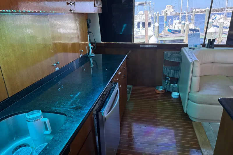 Slide: The Image of Interior of 1987 Ocean Yachts 63 Convertible Manns with kitchen and seating area. - 9