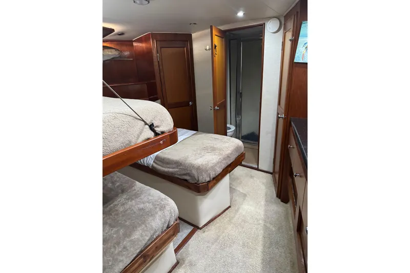 Slide: The Image of Interior of 1987 Ocean Yachts 63 Convertible Manns with cozy bunk beds and bathroom. - 12