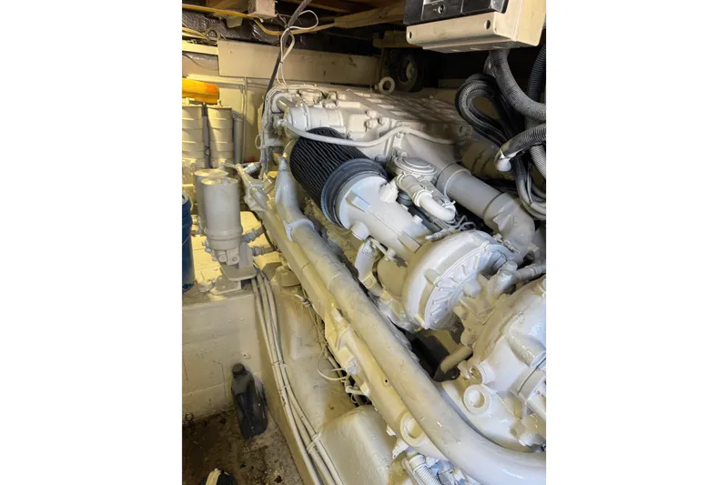 Slide: The Image of Engine room of 1987 Ocean Yachts 63 Convertible Manns, showcasing detailed machinery. - 22