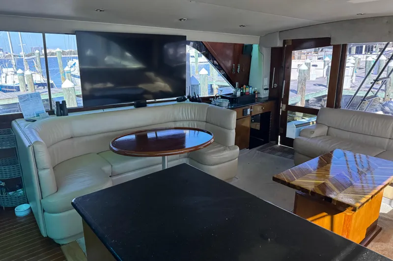 Slide: The Image of Luxurious interior of 1987 Ocean Yachts 63 convertible Manns with leather seating and large TV. - 7