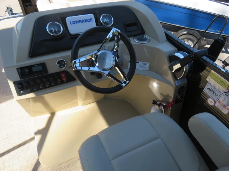 Slide: The Image of 2023 Crest Classic LX 220 boat dashboard with steering wheel and control panel. - 4