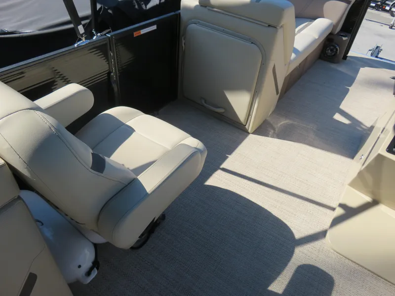 Slide: The Image of 2023 Crest Classic LX 220 boat interior with beige seating and carpet flooring. - 6