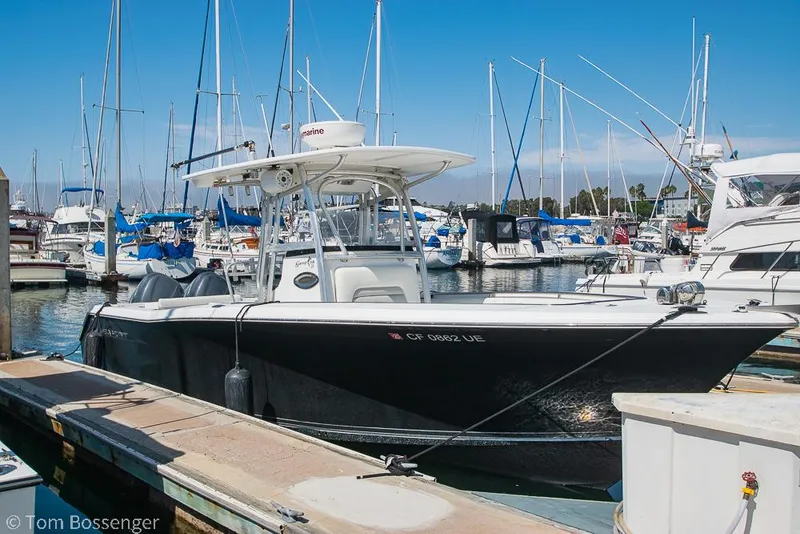 Slide: The Image of 2010 Sea Hunt Gamefish 29 boat docked in a marina with sailboats in the background. - 1