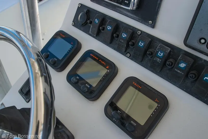 Slide: The Image of Control panel of a 2010 Sea Hunt Gamefish 29 boat with gauges and switches. - 11