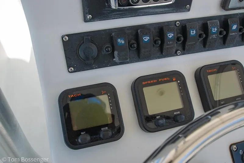 Slide: The Image of Control panel of a 2010 Sea Hunt Gamefish 29 boat with gauges and switches. - 12
