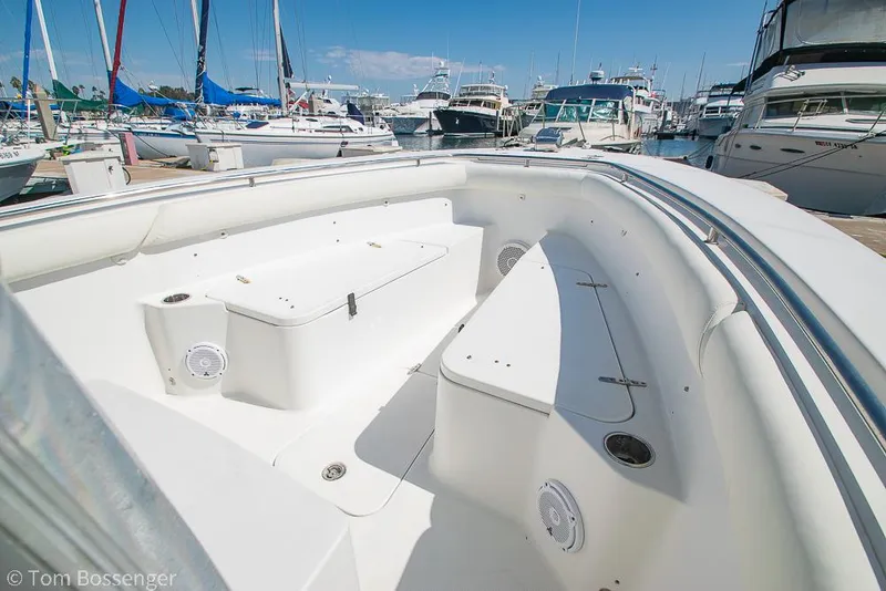 Slide: The Image of 2010 Sea Hunt Gamefish 29 boat interior at marina, showcasing seating and storage. - 16